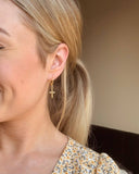 Gold cross charm earrings